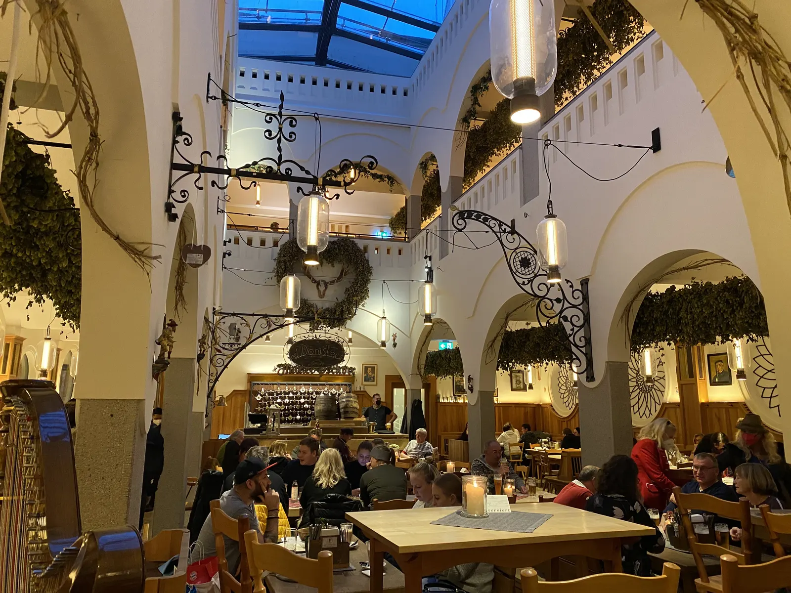 The vaulted, painted ceiling and long communal tables of the Hofbräuhaus beer hall in Munich