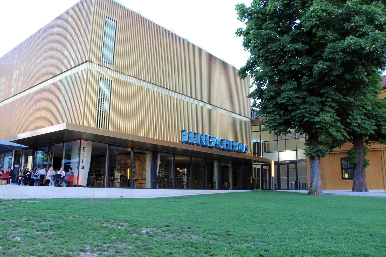 The Städtische Galerie im Lenbachhaus in Munich — the golden Foster extension and café terrace beside the historic villa wing
